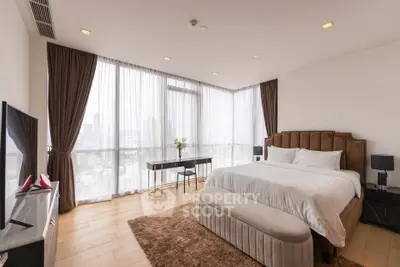 Luxurious bedroom with panoramic city views and elegant furnishings