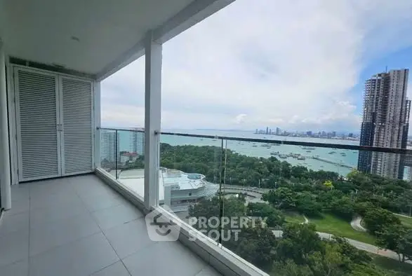 Stunning balcony with panoramic city and ocean views, perfect for relaxation.