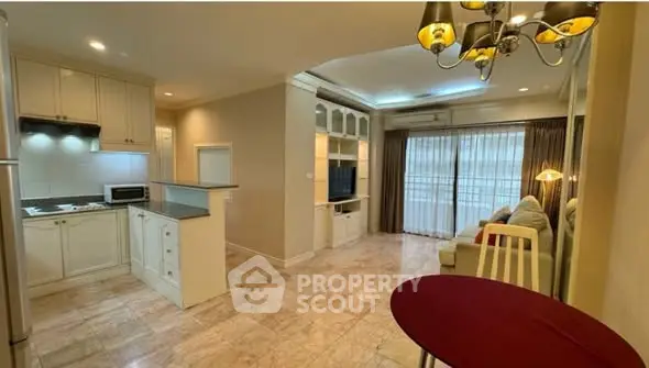 Spacious open-plan living room with elegant kitchen and cozy seating area, perfect for modern living.