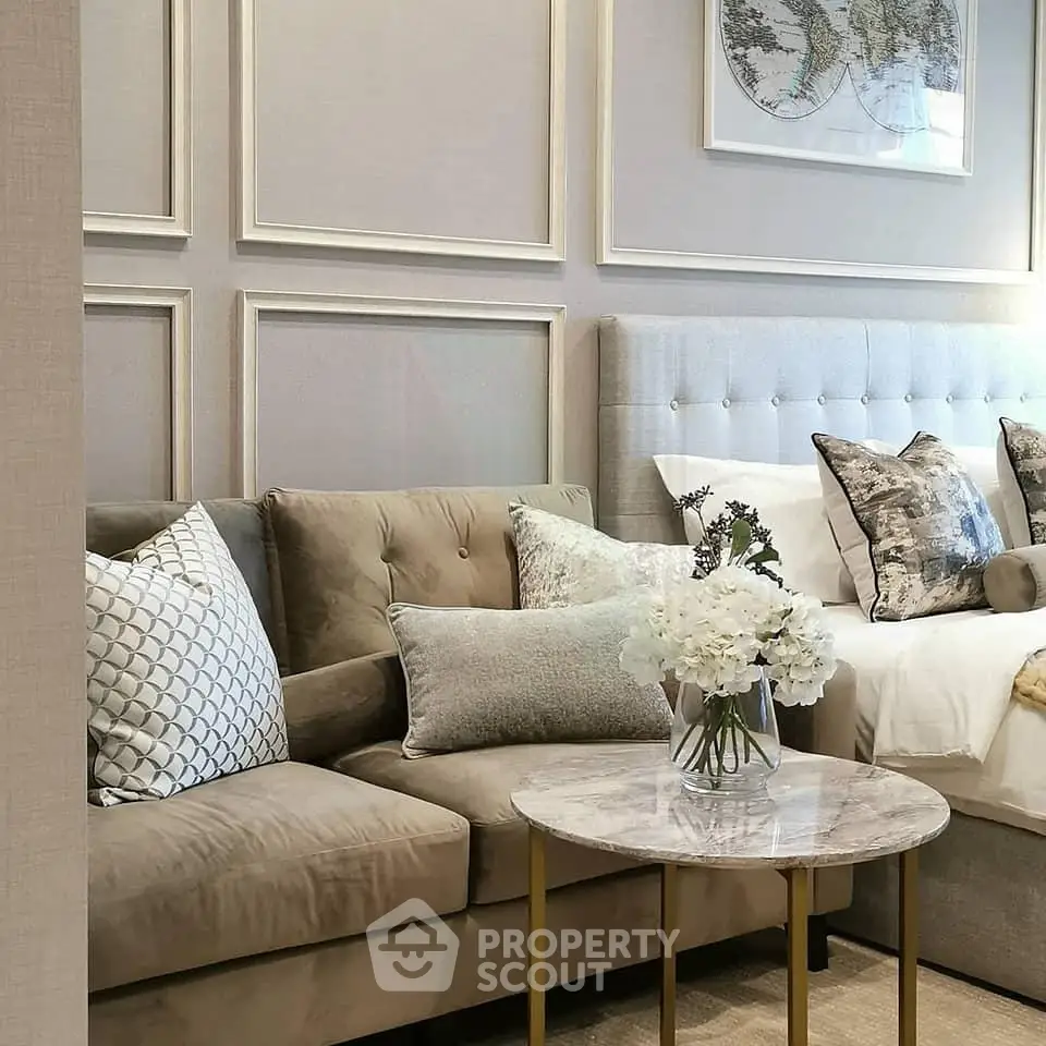Elegant living room with plush sofa, stylish cushions, and chic decor in a modern apartment.