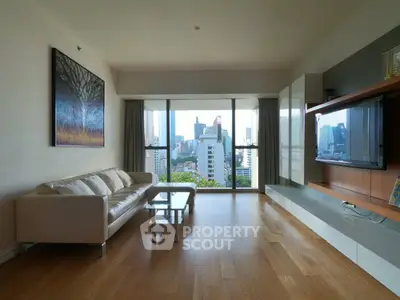 Spacious modern living room with city view, hardwood floors, and stylish decor.