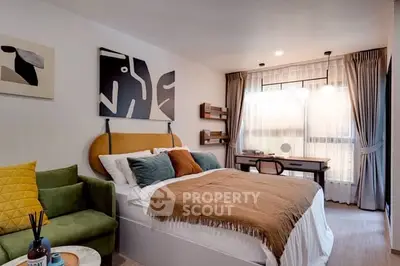 Stylish bedroom with modern decor and natural light, featuring a cozy bed and work desk.