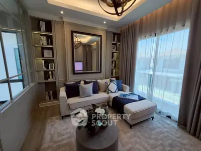 Elegant living room with cozy sofa, large window, and stylish decor in a modern home.