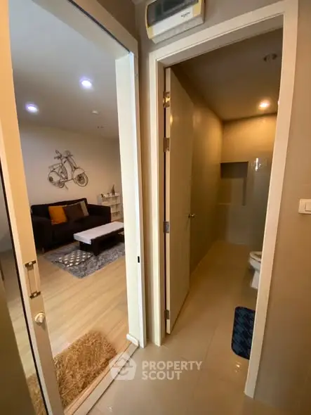 Modern apartment interior with cozy living room and adjacent bathroom