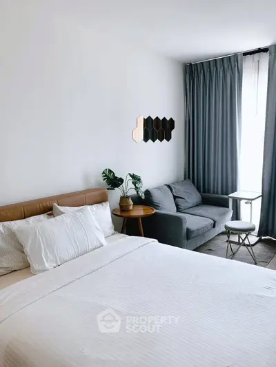 Modern bedroom with cozy seating area and stylish decor