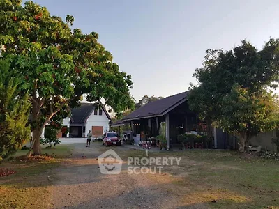 Charming countryside property with spacious yard and lush greenery, perfect for serene living.