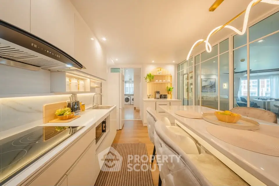 Luxurious open-layout kitchen with modern appliances and elegant dining area