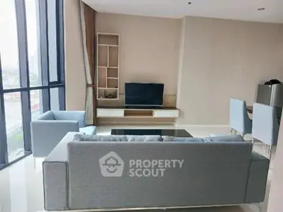 Spacious modern living room with large windows and stylish furniture
