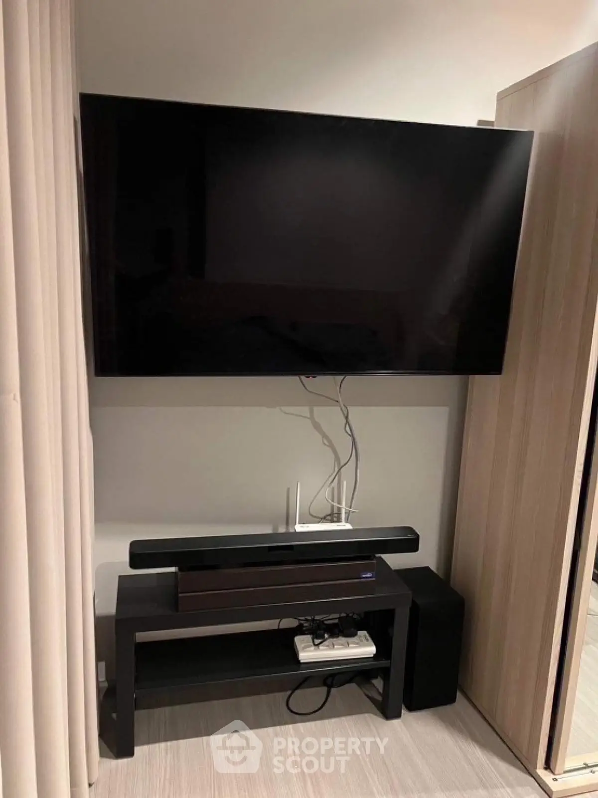 Modern living room with wall-mounted TV and sleek entertainment unit