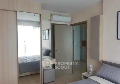 Modern bedroom with mirrored wardrobe and air conditioning in stylish apartment.