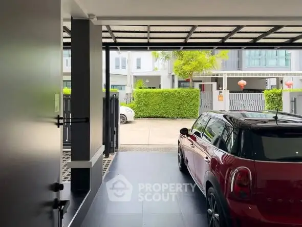 Modern residential garage with sleek design and parked car, showcasing contemporary architecture.