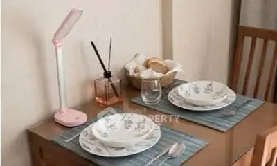 Cozy dining setup with elegant tableware and ambient lighting in a stylish home interior.