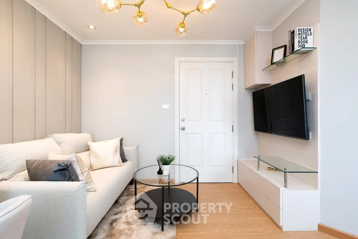 Stylish modern living room with cozy sofa, sleek TV setup, and elegant lighting.