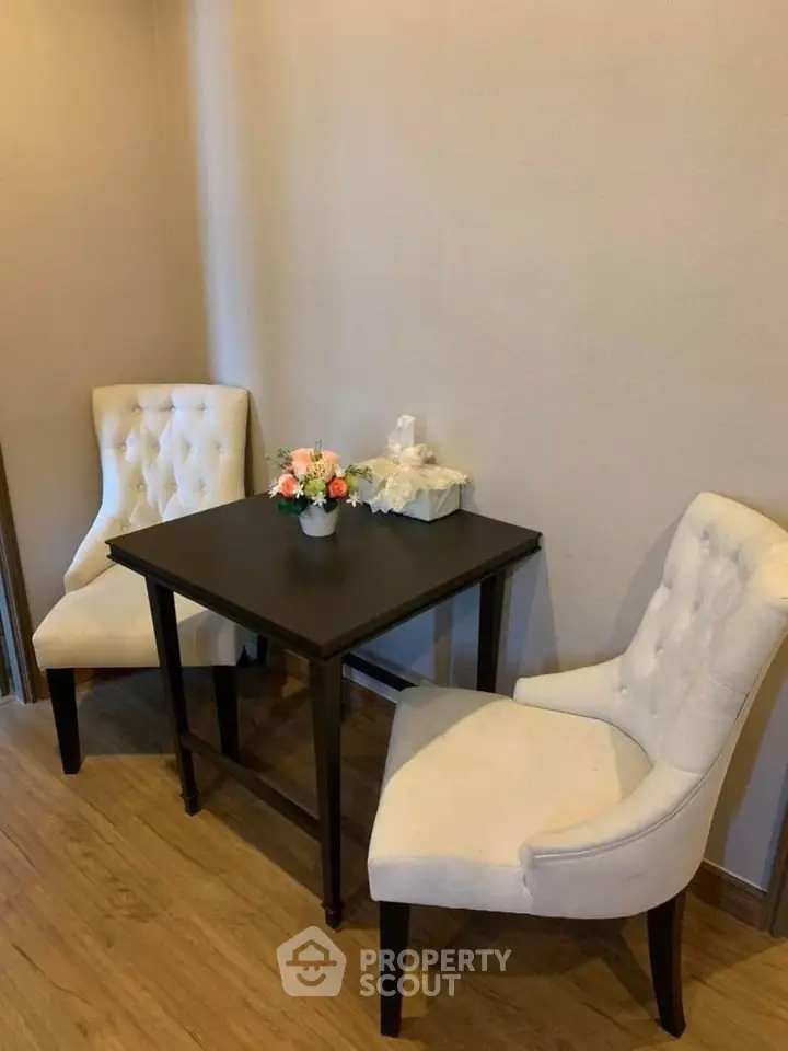 Cozy dining nook with elegant chairs and a small table, perfect for intimate meals.