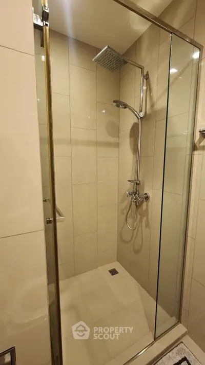 Modern bathroom with glass shower enclosure and rainfall showerhead