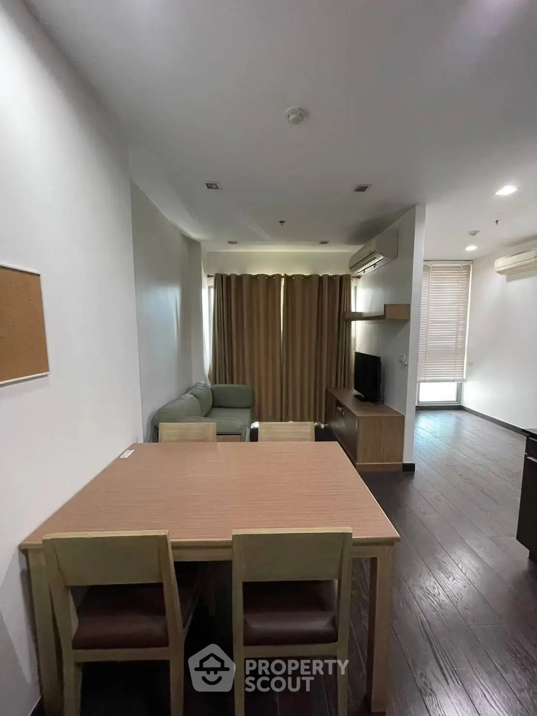 Modern living room with dining area and stylish furniture in a cozy apartment.