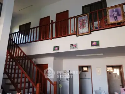 Spacious two-story living area with wooden staircase and modern decor
