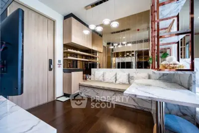 Modern living room with marble accents and elegant lighting in a stylish apartment.