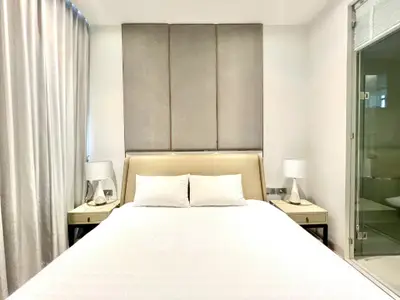 Modern bedroom with elegant decor and ensuite bathroom in luxury apartment