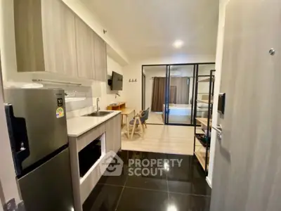 Modern studio apartment with sleek kitchen and open layout