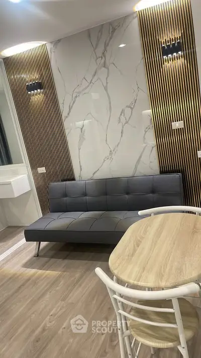 Modern living room with stylish marble accent wall and sleek furniture