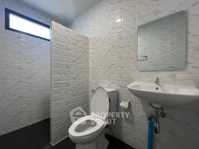 Modern bathroom with sleek white tiles and compact design
