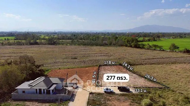 Scenic land plot with countryside views and a small house, ideal for development.