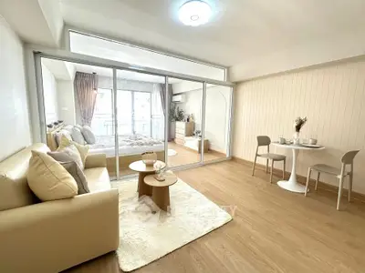 Spacious modern living room with cozy decor and open view to bedroom