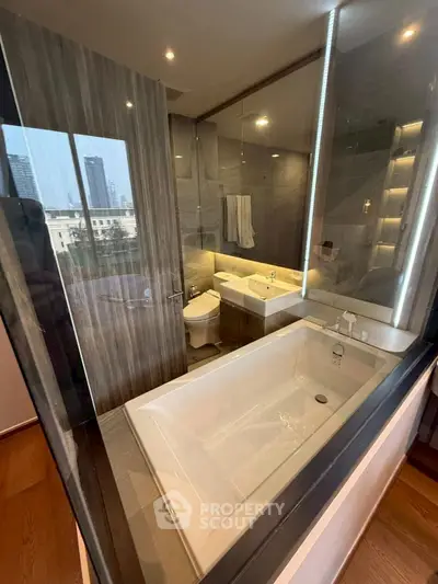 Luxurious modern bathroom with glass walls and city view