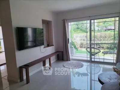 Modern living room with garden view and sleek TV setup