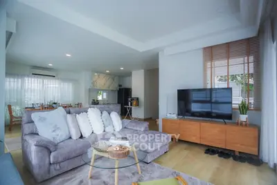 Spacious modern living room with cozy seating and open layout kitchen, perfect for entertaining.