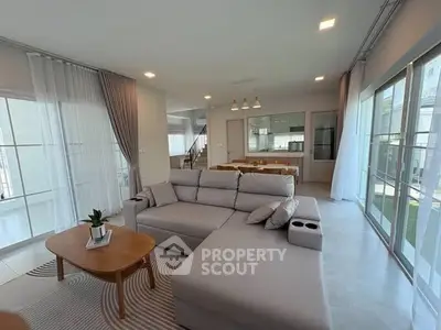 Spacious modern living room with large windows and elegant decor