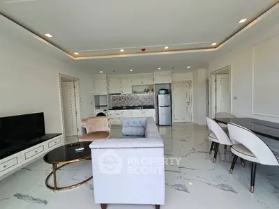 Spacious modern living room with elegant furniture and open kitchen layout