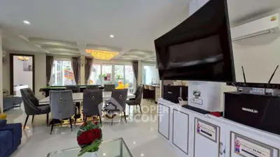 Spacious modern living room with elegant dining area and large TV