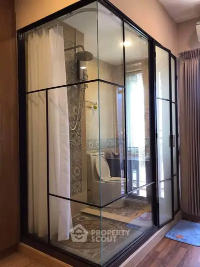 Modern bathroom with glass-enclosed shower and elegant tile design