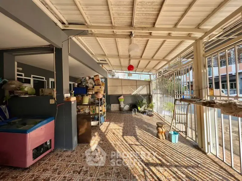 Spacious covered patio with storage potential and natural light