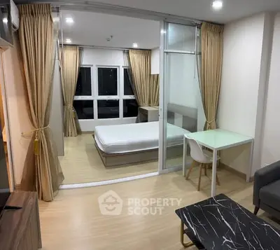 Modern bedroom with glass partition, elegant curtains, and sleek furniture design.