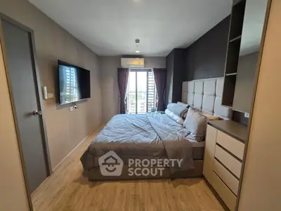 Modern bedroom with stylish decor and natural light from large window.
