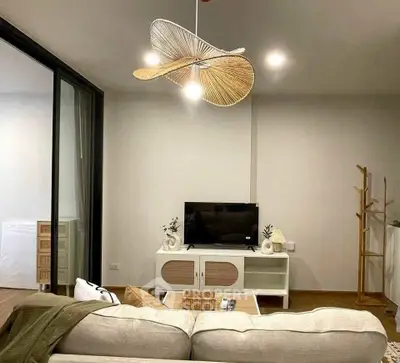 Stylish living room with modern decor and unique ceiling fan design.