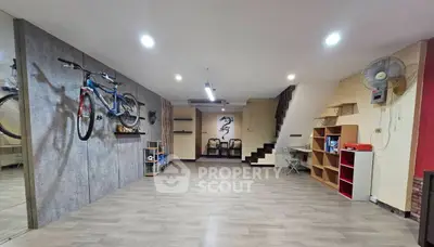 Spacious modern living area with wall-mounted bike and stylish decor