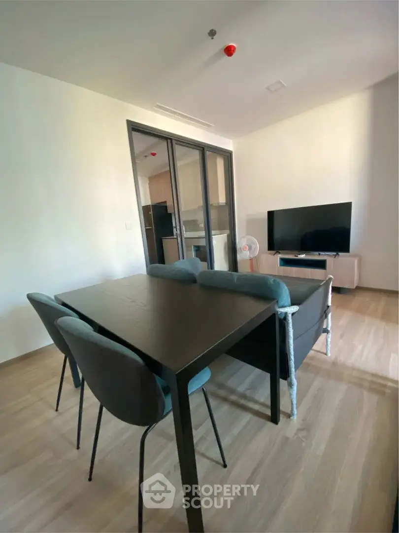Modern living room with dining area and TV in open layout apartment