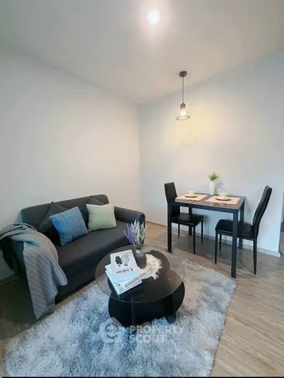 Modern living room with cozy sofa, stylish dining set, and chic decor in a bright, inviting space.