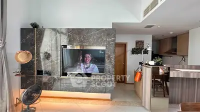 Modern living room with marble TV wall and stylish kitchen area