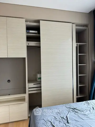 Modern bedroom with built-in wardrobe and sleek design