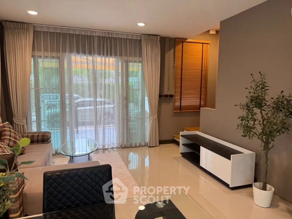 Spacious living room with modern decor and large windows for natural light.