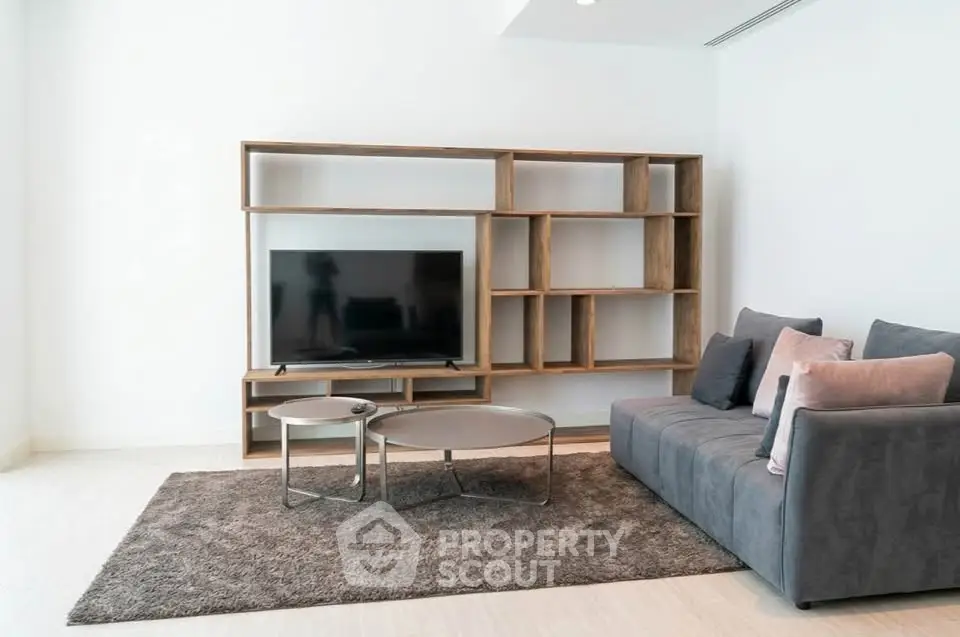 Modern living room with sleek TV unit and cozy gray sofa