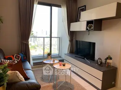 Modern living room with large window and stylish decor in a high-rise apartment.