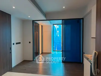 Modern apartment interior with sliding glass doors and wooden flooring