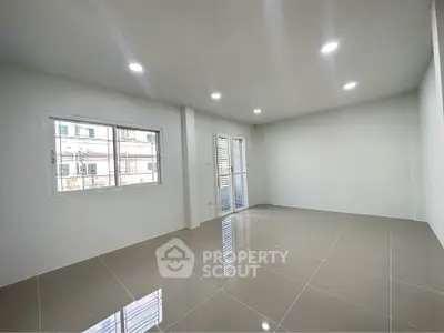 Spacious empty room with large windows and glossy tiled floor, perfect for customization.