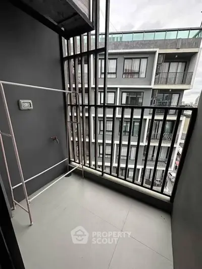 Modern apartment balcony with sleek railing and urban view